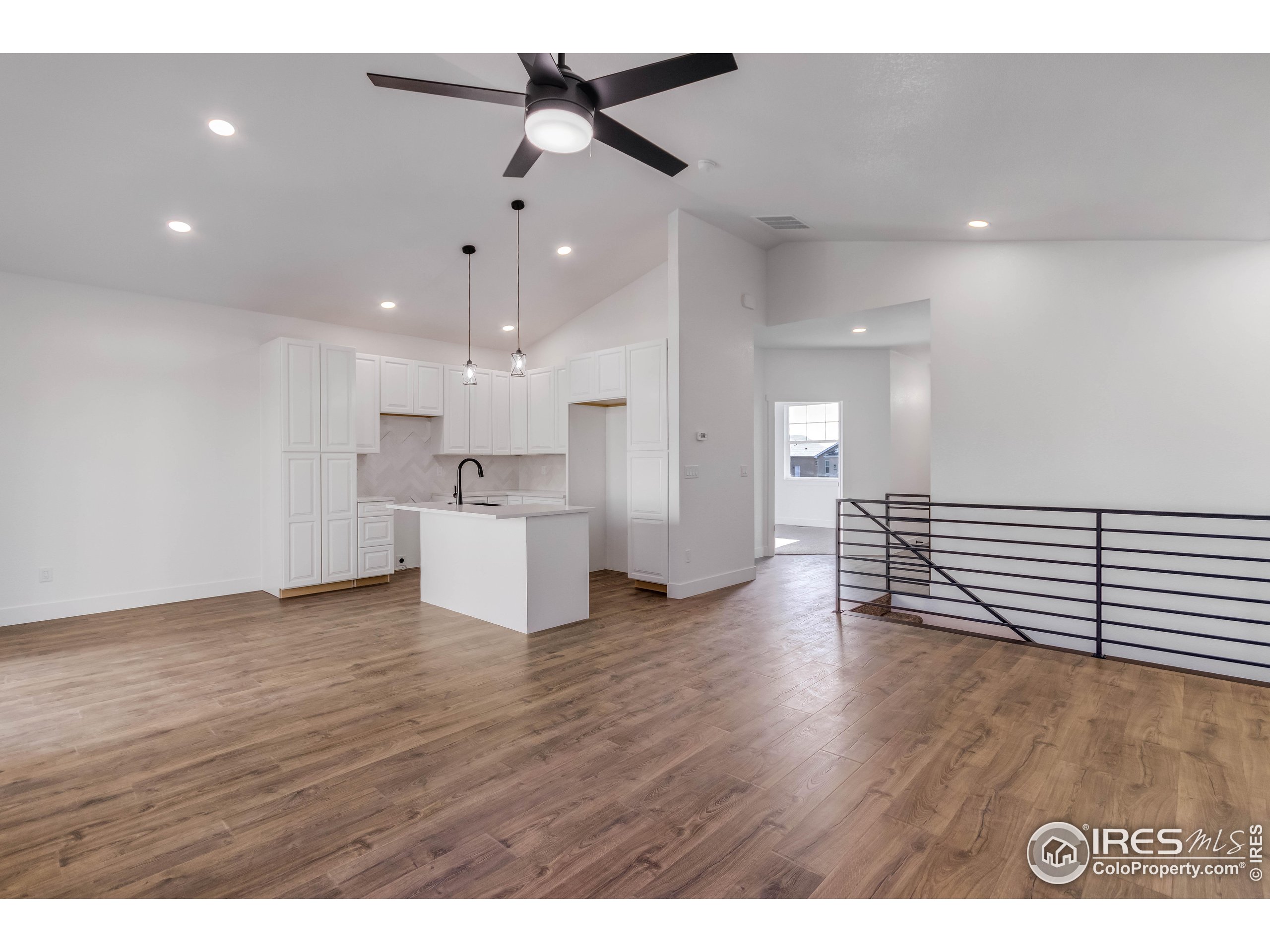 1230 Swainson Road Eaton, CO 80615 - Photo 10 of 35 a view of a kitchen with a dishwasher cabinets and wooden floor