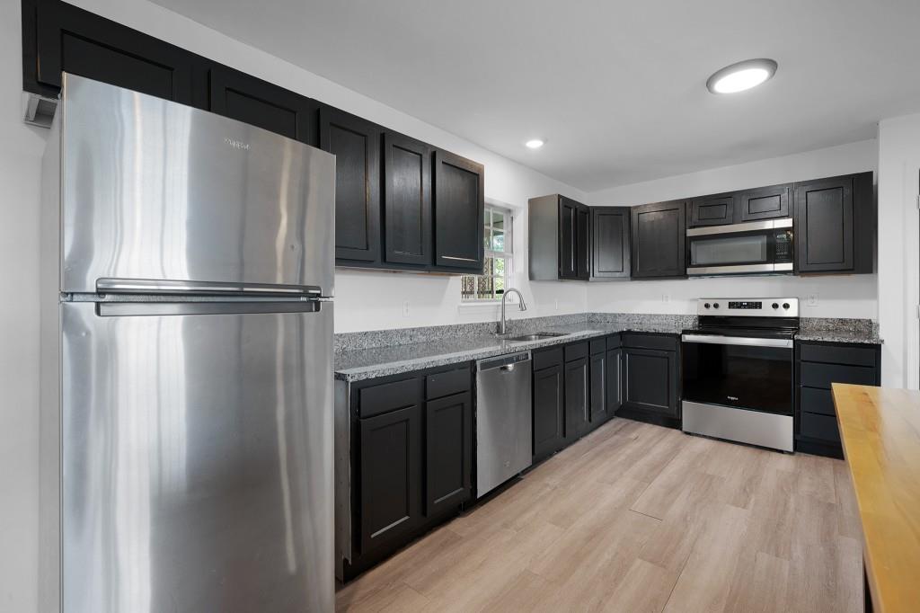 1717 East Rebel Road Rossville, GA 30741 - Photo 11 of 36 a kitchen with kitchen island a counter top space stainless steel appliances and cabinets