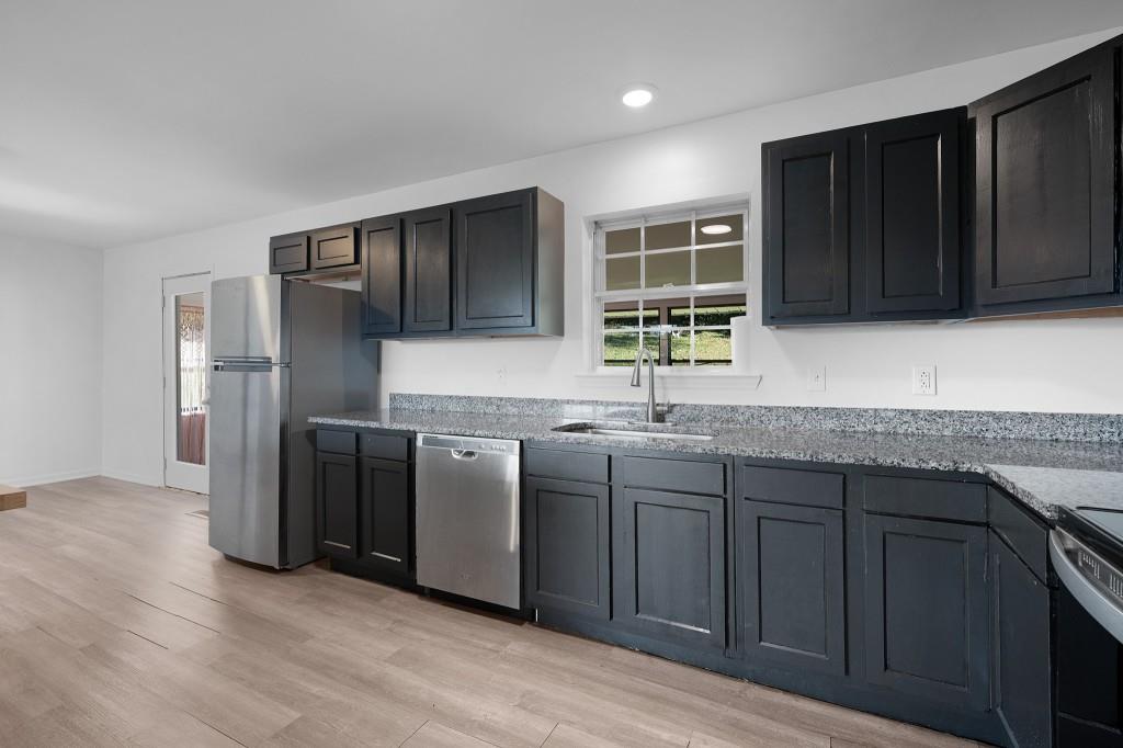 1717 East Rebel Road Rossville, GA 30741 - Photo 12 of 36 a kitchen with stainless steel appliances granite countertop a refrigerator and a sink