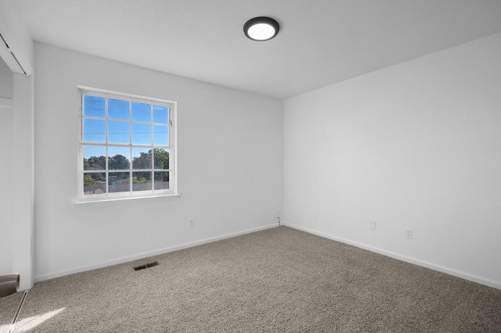 1717 East Rebel Road Rossville, GA 30741 - Photo 18 of 36 an empty room with a window