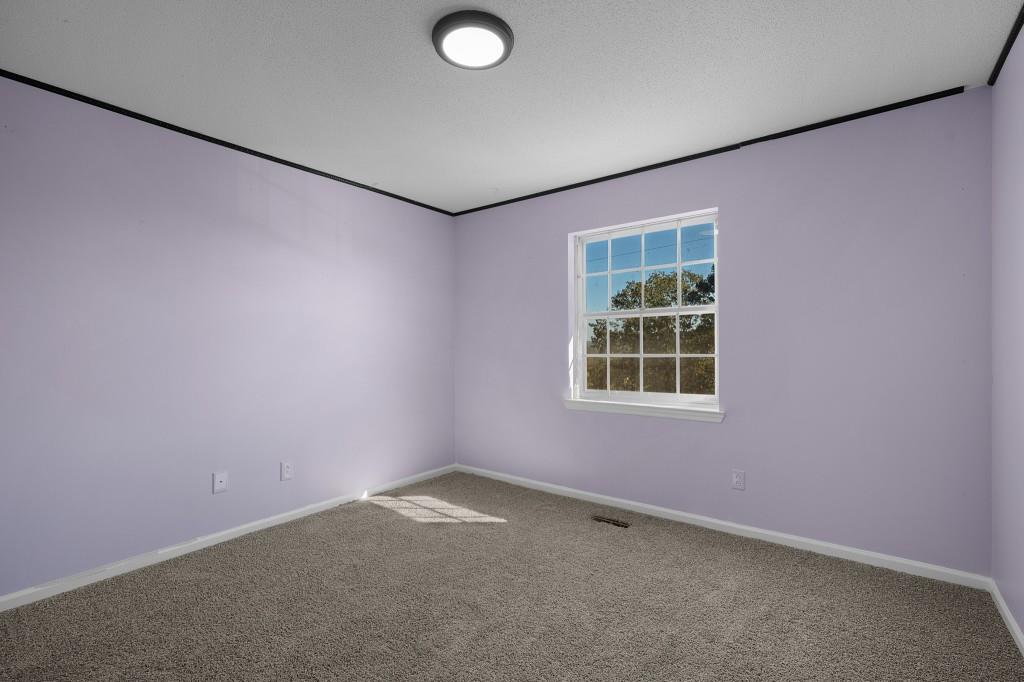 1717 East Rebel Road Rossville, GA 30741 - Photo 20 of 36 an empty room with a window