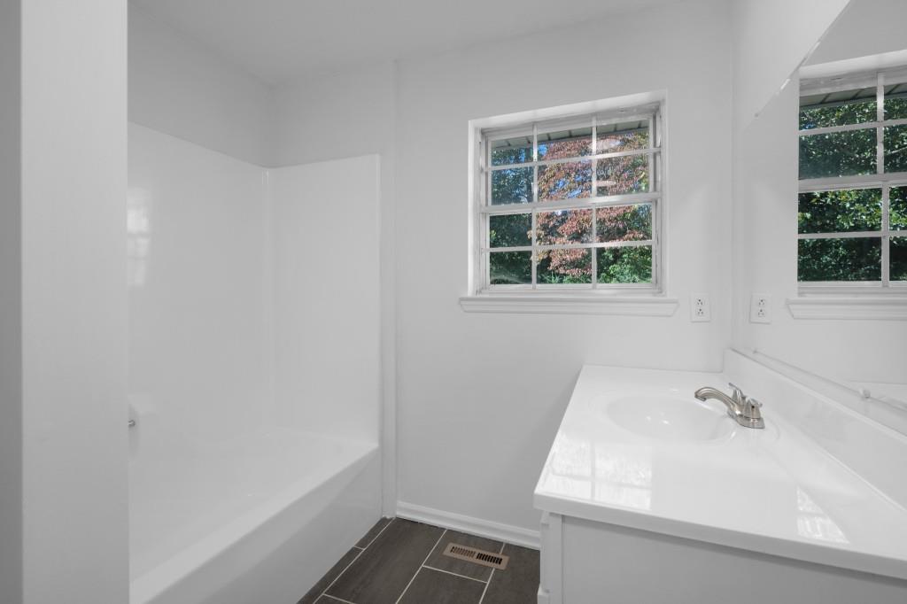 1717 East Rebel Road Rossville, GA 30741 - Photo 21 of 36 a bathroom with a sink and a window
