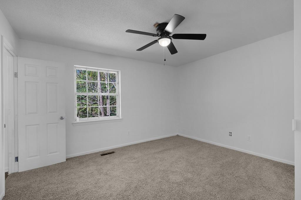 1717 East Rebel Road Rossville, GA 30741 - Photo 23 of 36 an empty room with a window and a fan