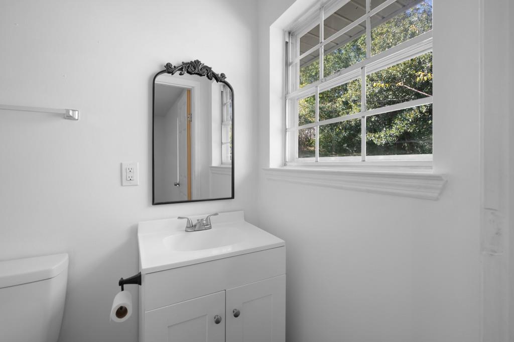 1717 East Rebel Road Rossville, GA 30741 - Photo 25 of 36 a bathroom with a sink a mirror and a toilet