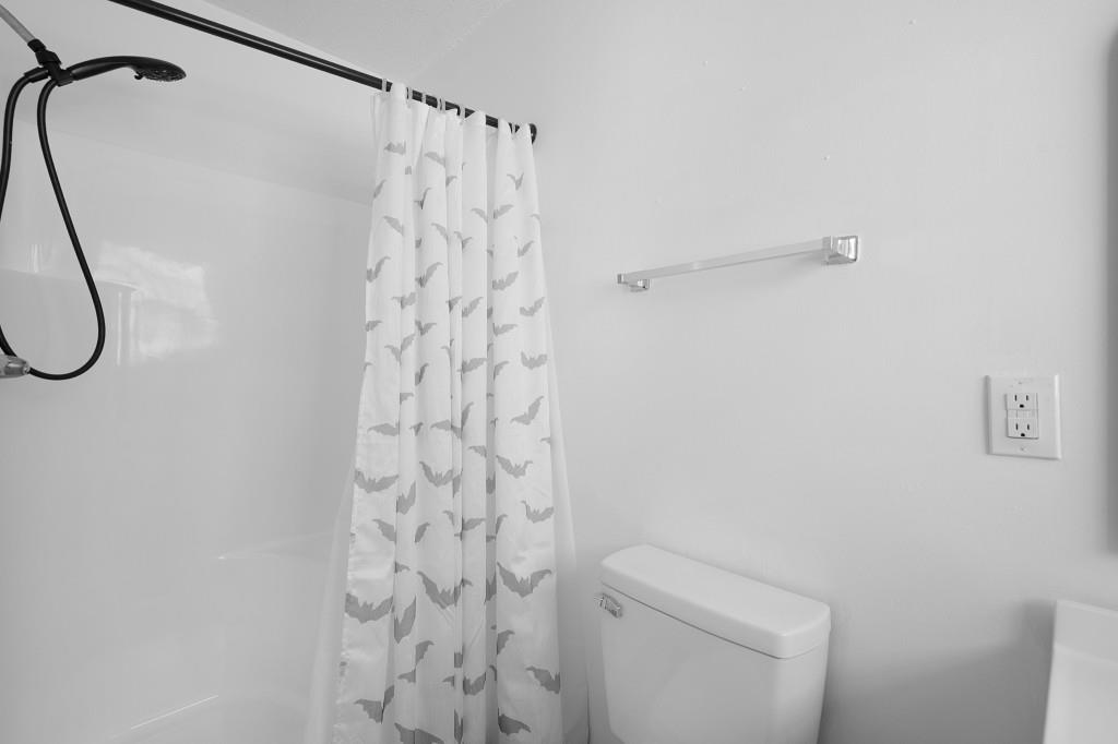 1717 East Rebel Road Rossville, GA 30741 - Photo 26 of 36 a bathroom with a shower toilet and a shower curtain