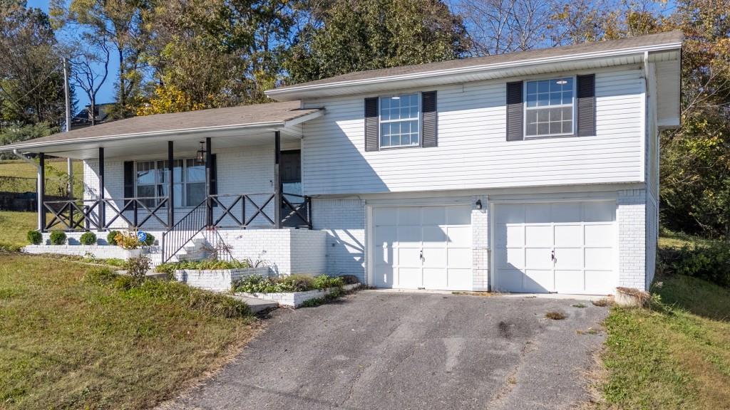 1717 East Rebel Road Rossville, GA 30741 - Photo 4 of 36 a front view of a house with garden