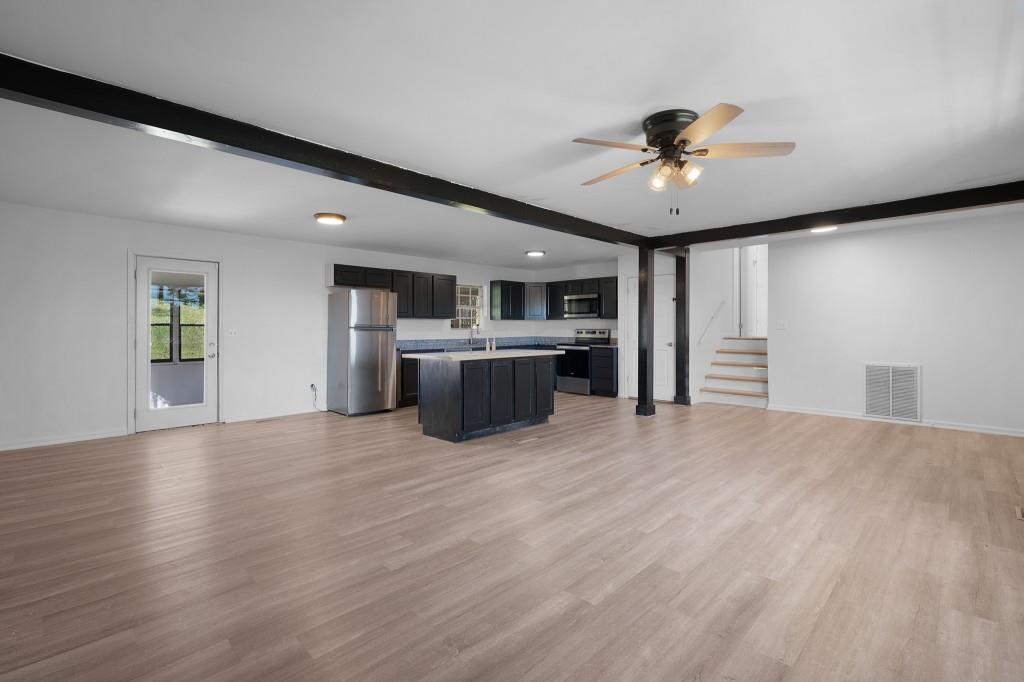 1717 East Rebel Road Rossville, GA 30741 - Photo 9 of 36 a view of a kitchen with a stove cabinets and wooden floor