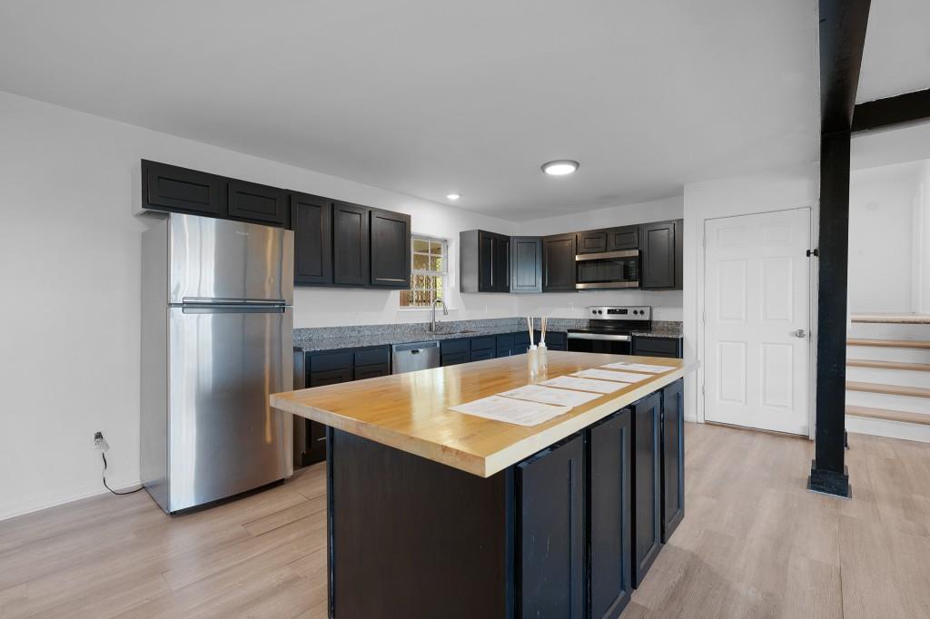 1717 East Rebel Road Rossville, GA 30741 - Photo 10 of 36 a kitchen with stainless steel appliances granite countertop a refrigerator a sink and a stove