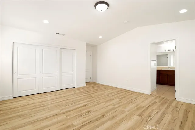 a view of a room with wooden floor and cabinet