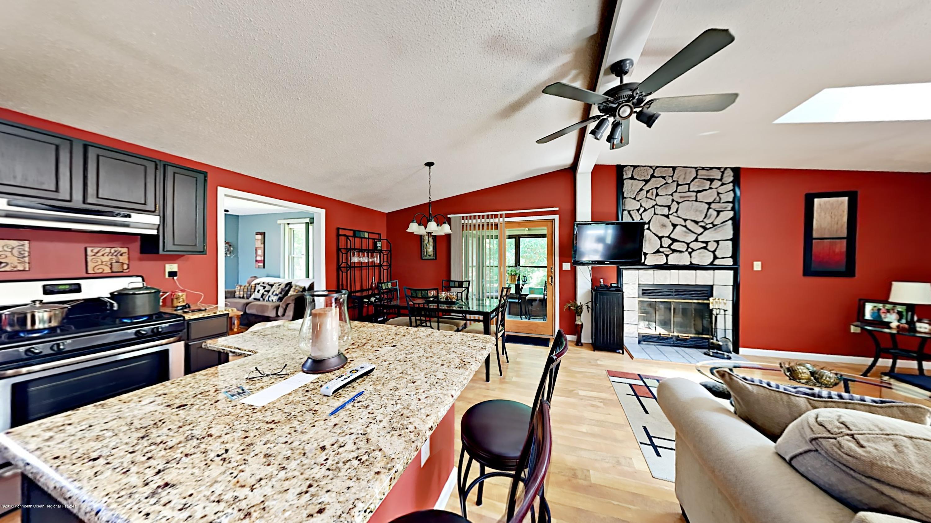 890 Anderson Road Jackson, NJ 08527 - Photo 1 of 17 a living room with furniture a rug and a fireplace