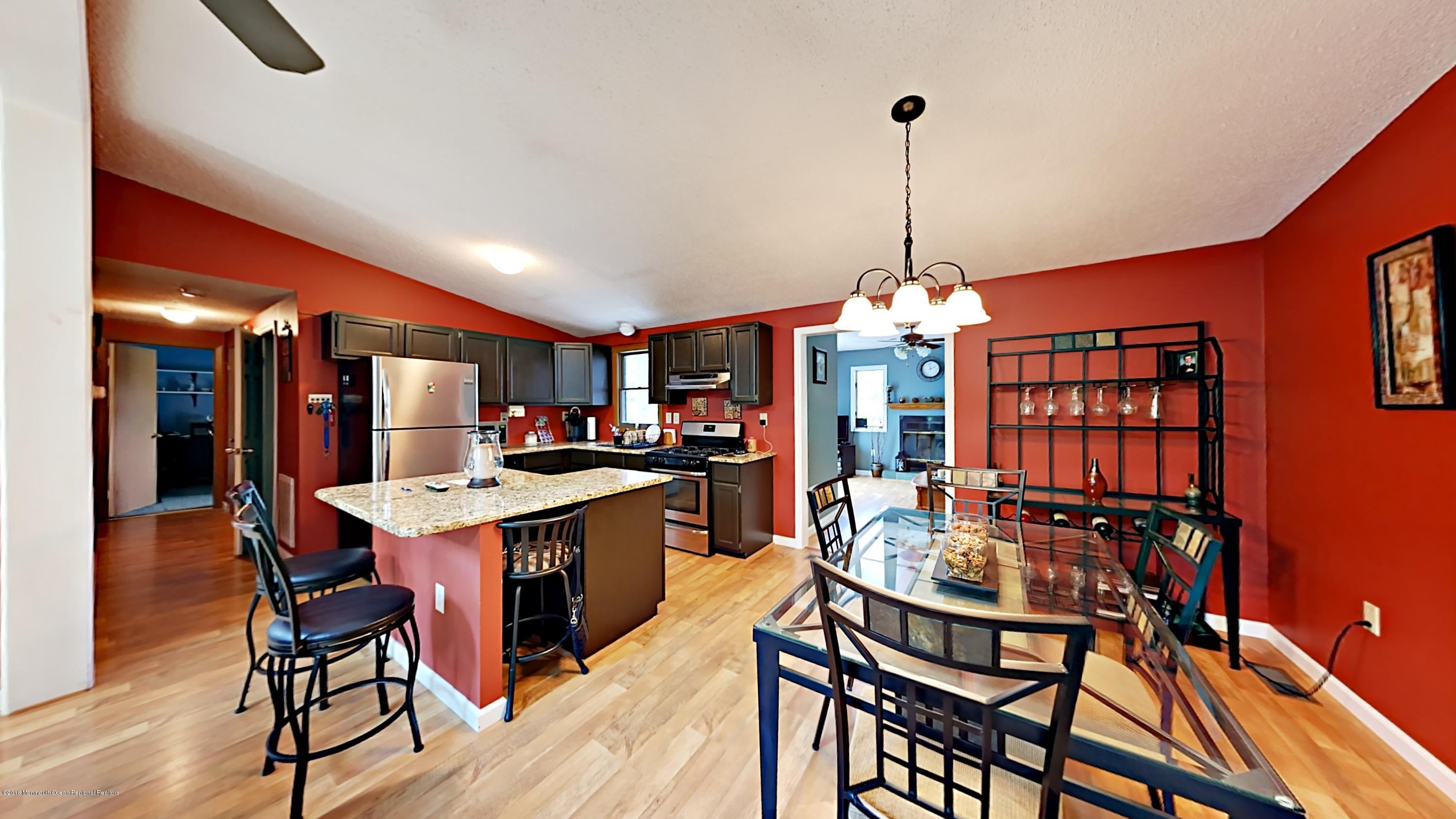 890 Anderson Road Jackson, NJ 08527 - Photo 3 of 17 a dining hall with stainless steel appliances granite countertop a dining table and chairs with wooden floor