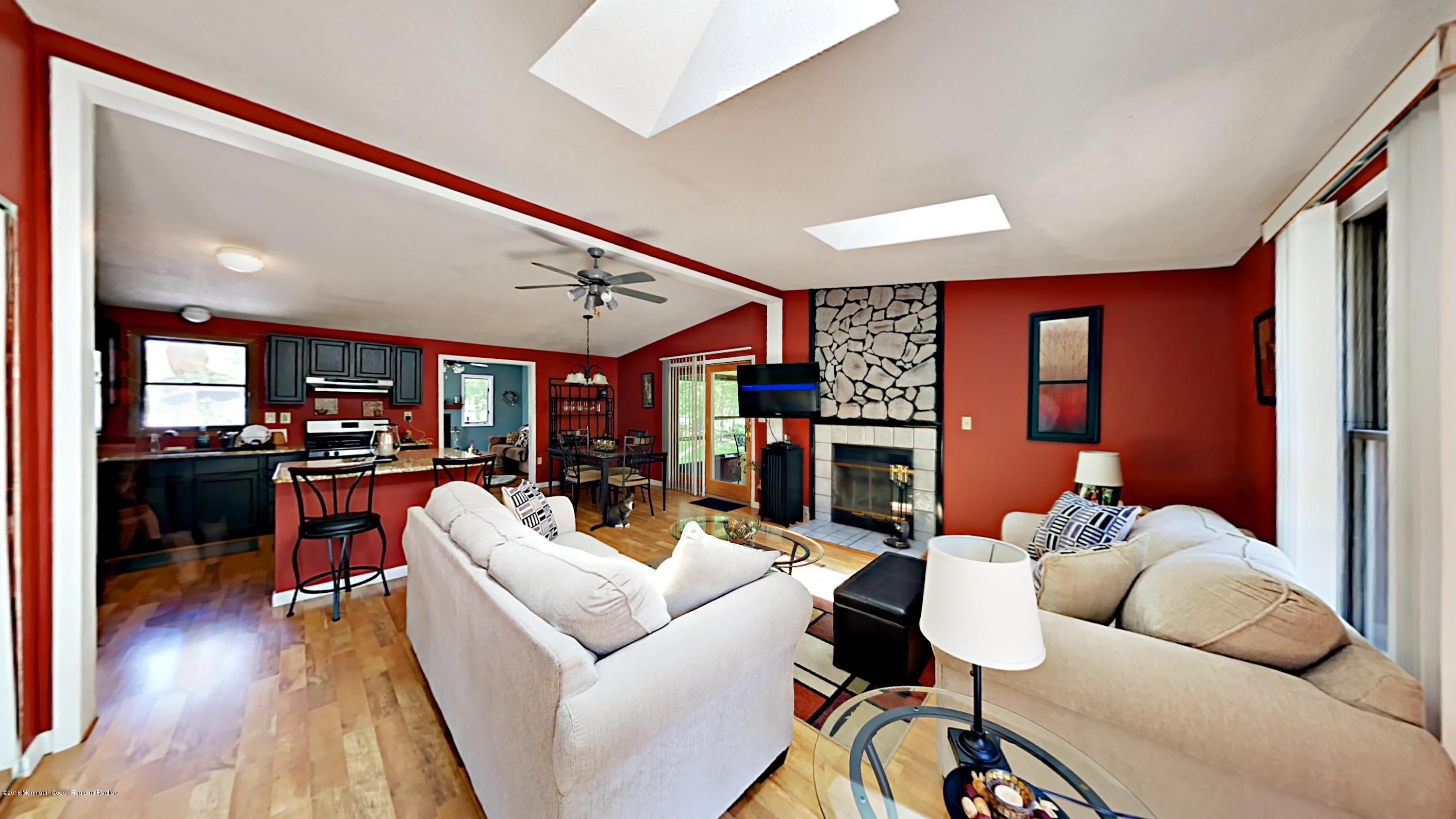 890 Anderson Road Jackson, NJ 08527 - Photo 4 of 17 a living room with fireplace furniture and a wooden floor