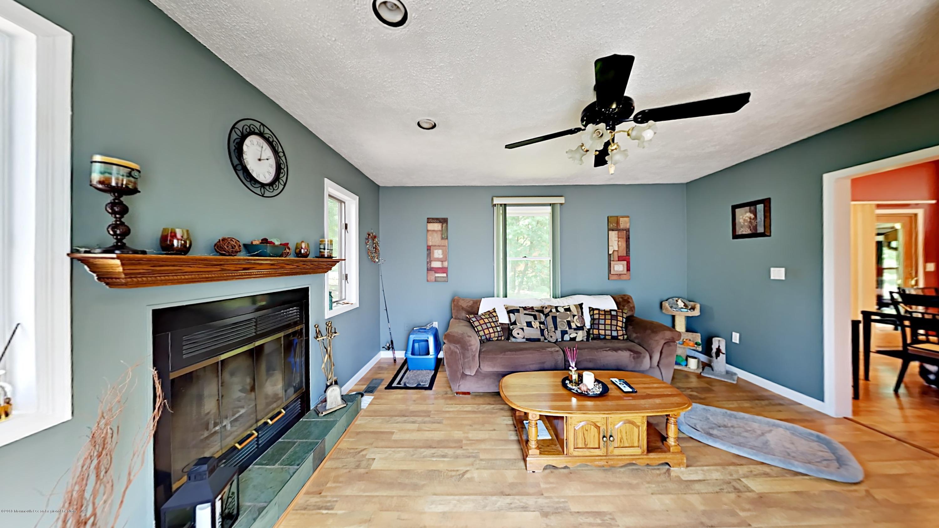 890 Anderson Road Jackson, NJ 08527 - Photo 5 of 17 a living room with furniture and a fireplace
