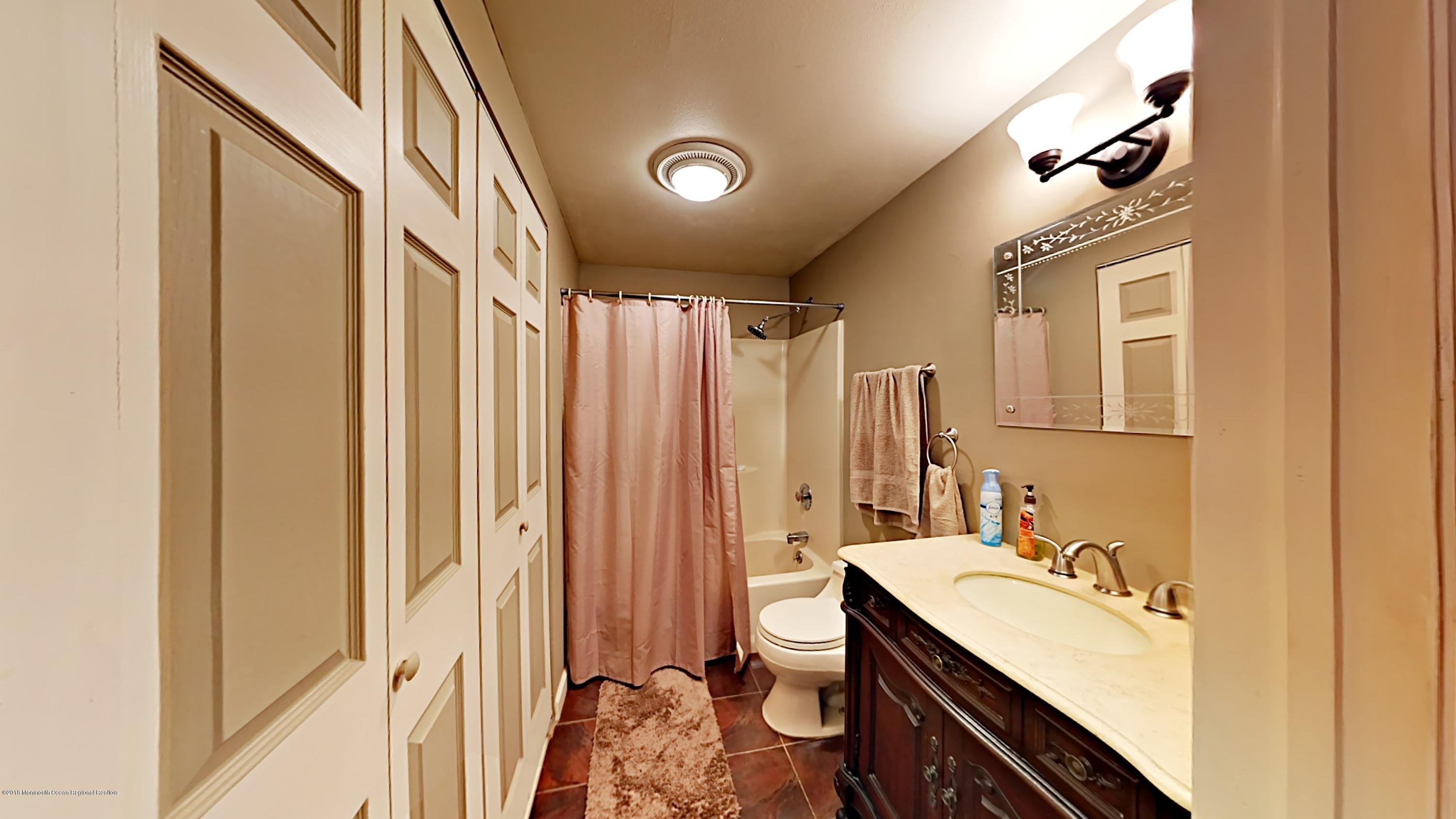 890 Anderson Road Jackson, NJ 08527 - Photo 8 of 17 a bathroom with a sink vanity granite and a mirror