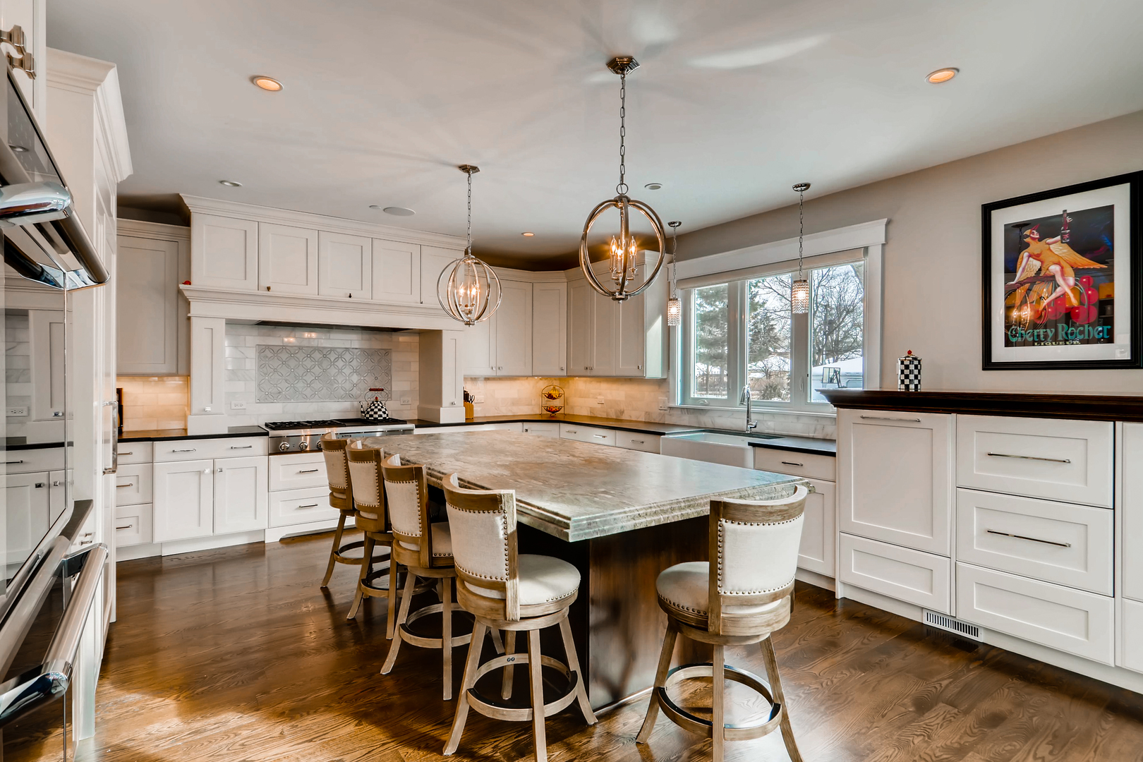 369 Downing Road Riverside, IL 60546 - Photo 14 of 46 a kitchen with stainless steel appliances kitchen island granite countertop a table chairs and wooden floor