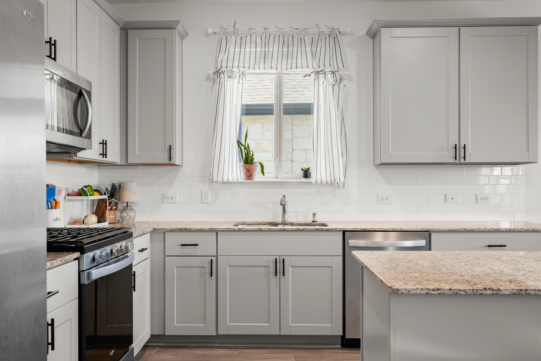 500 Pickrell Loop Georgetown, TX 78628 - Photo 6 of 29 a kitchen with stainless steel appliances granite countertop a sink stove and cabinets