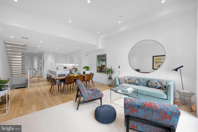 a living room with furniture and a large mirror
