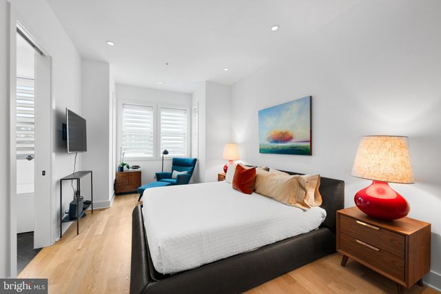 a bedroom with a bed and flat screen tv