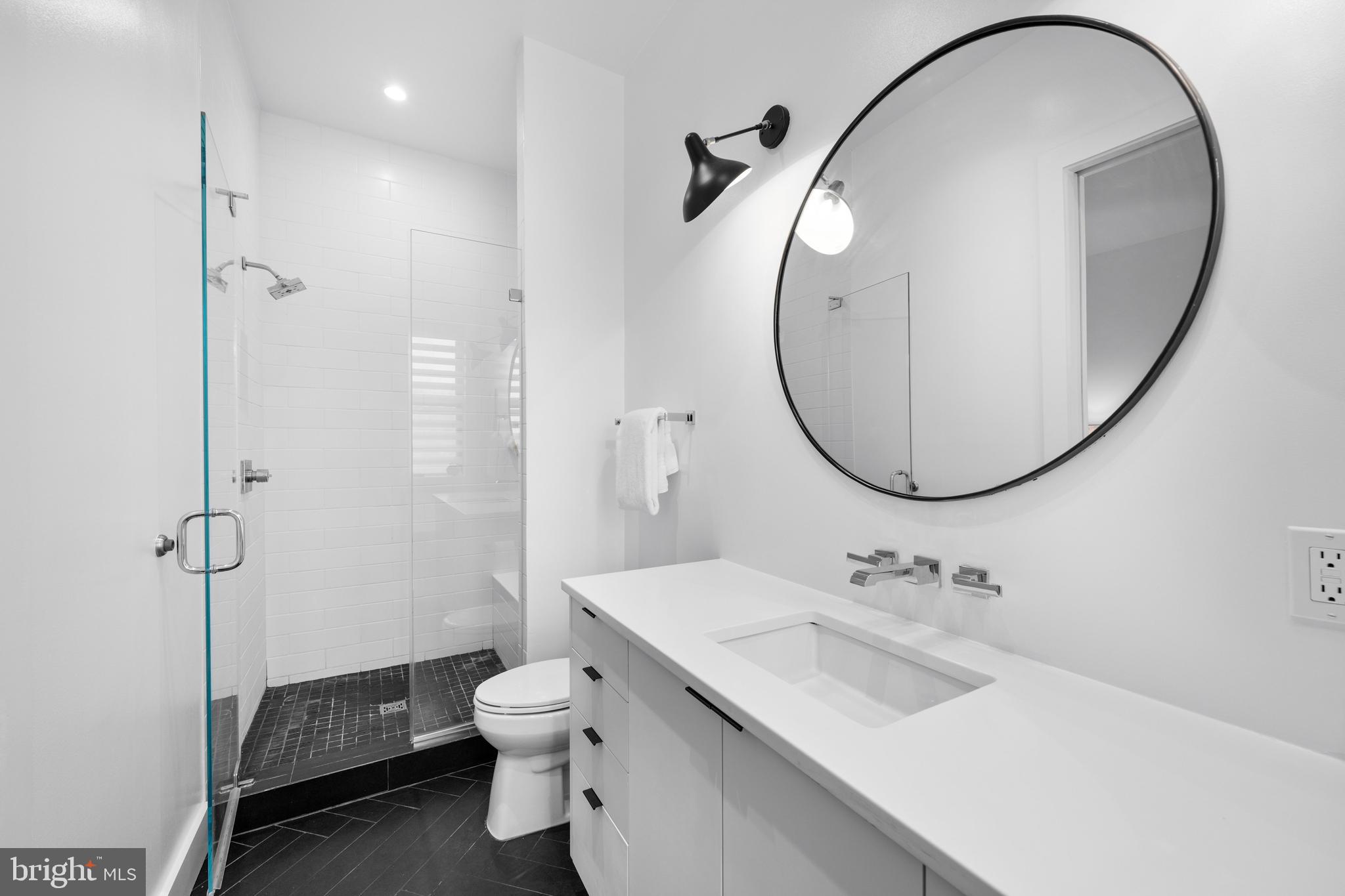 1806 9th Street Northwest, Unit 2 Washington, DC 20001 - Photo 20 of 40 a bathroom with a sink a toilet and a mirror