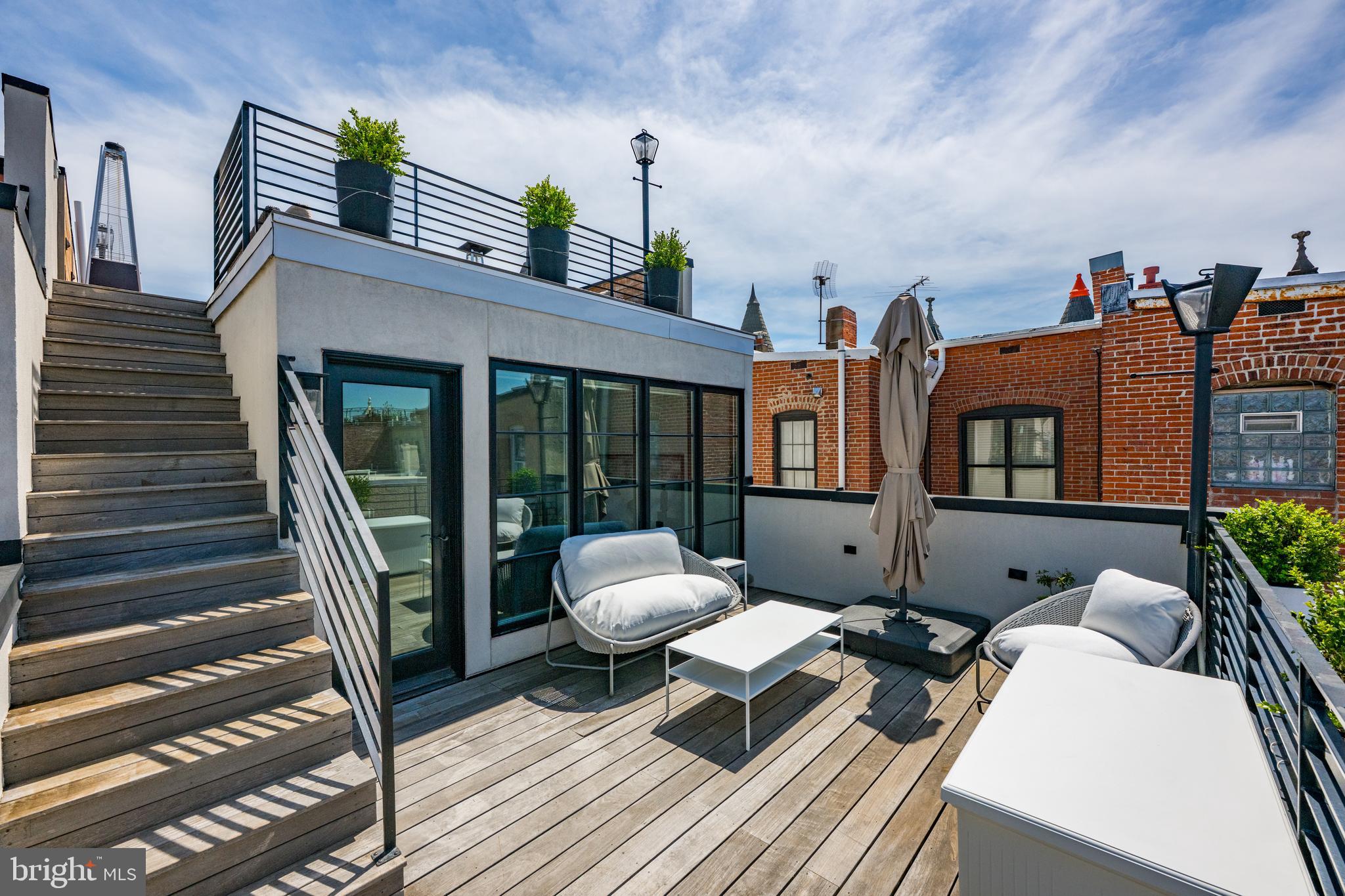 1806 9th Street Northwest, Unit 2 Washington, DC 20001 - Photo 29 of 40 a balcony with wooden floor and outdoor seating