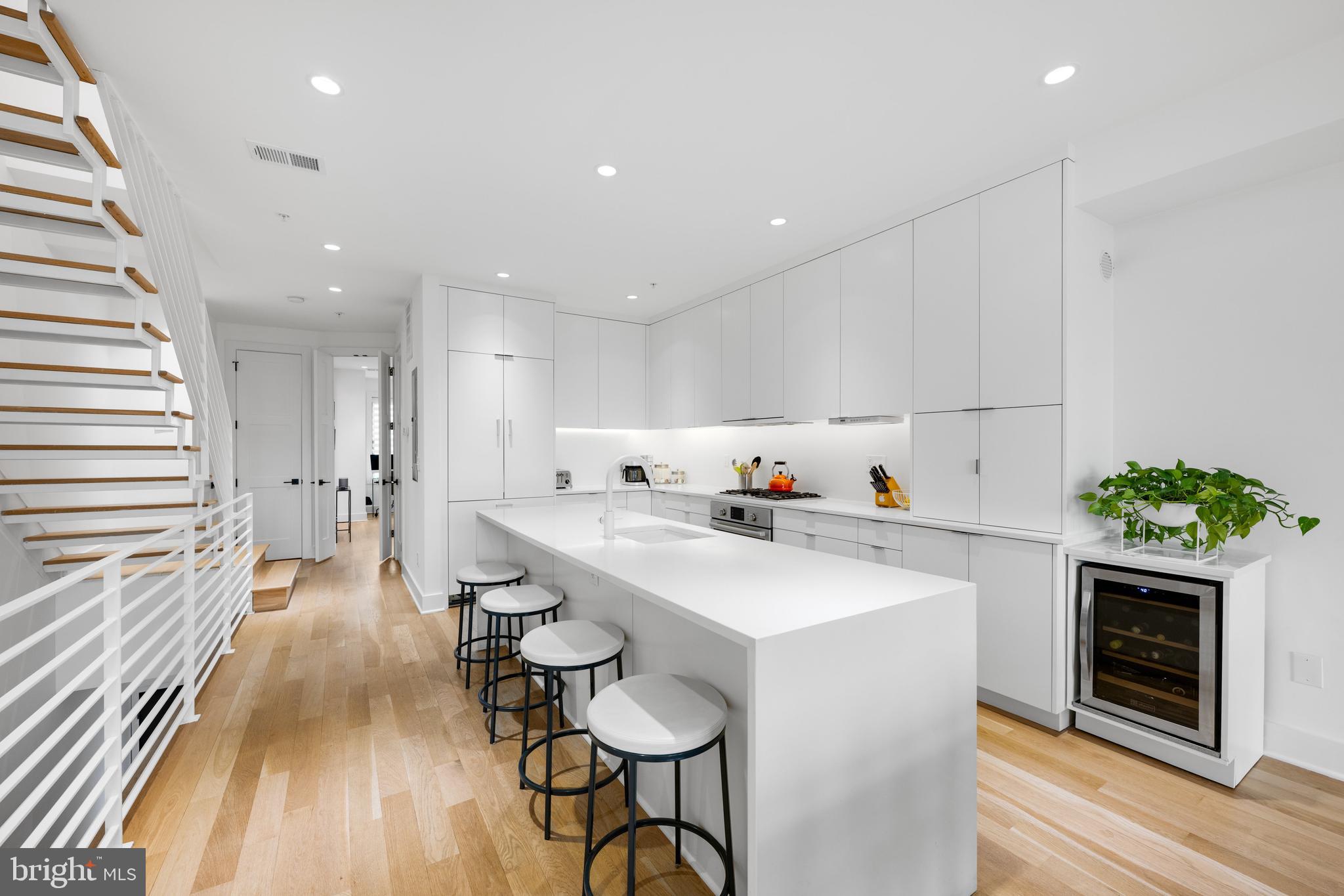 1806 9th Street Northwest, Unit 2 Washington, DC 20001 - Photo 3 of 40 a kitchen with white cabinets and stainless steel appliances