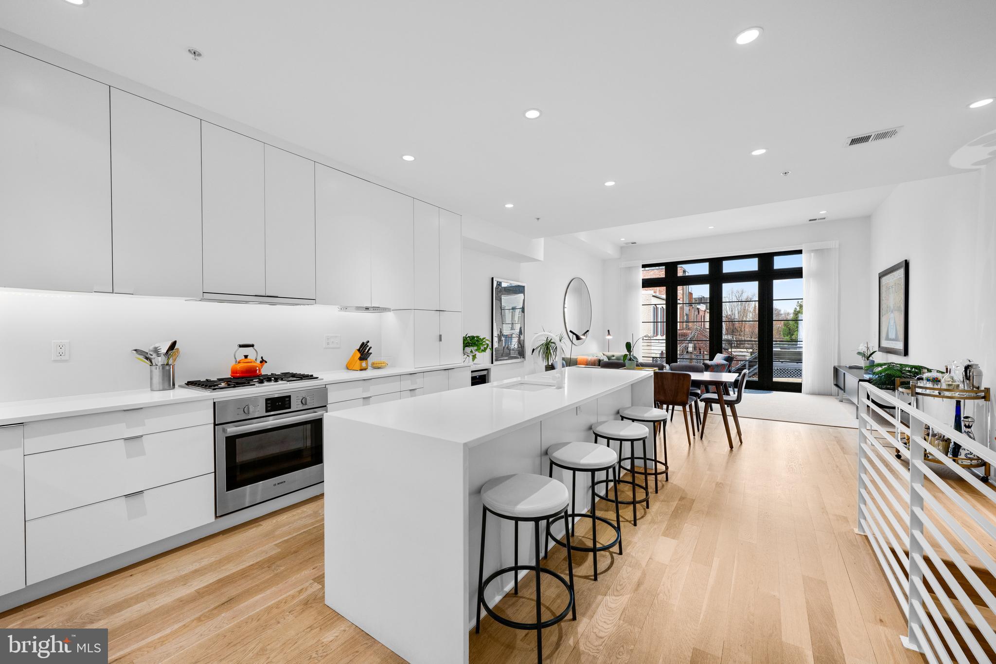 1806 9th Street Northwest, Unit 2 Washington, DC 20001 - Photo 6 of 40 a kitchen with white cabinets and white appliances