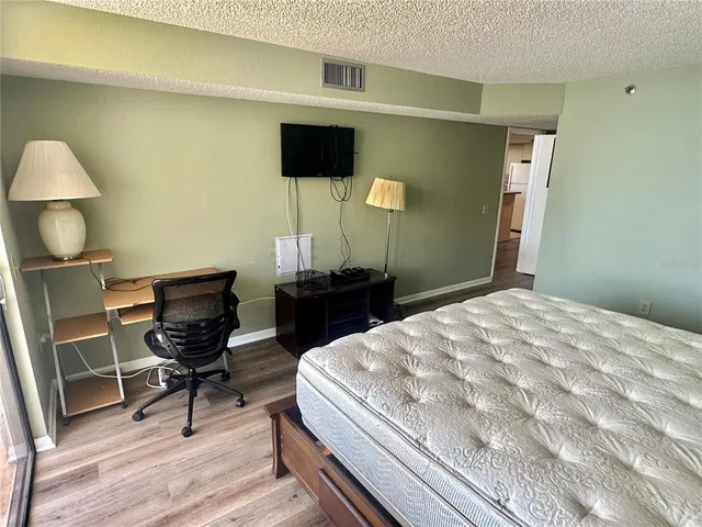 a bedroom with a bed and a chair