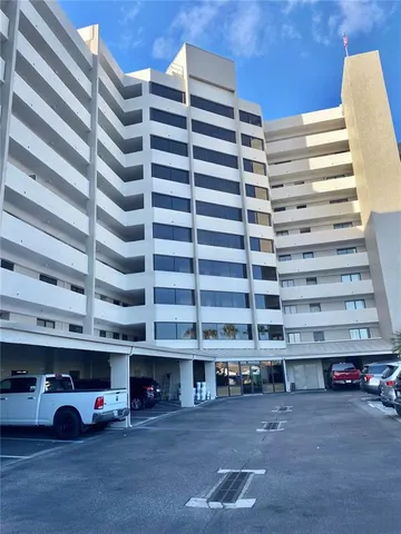 a view of a building with parking space