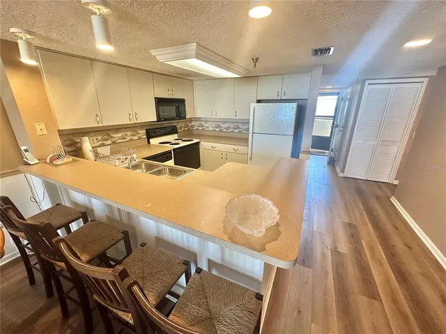 a kitchen with a sink appliances and cabinets