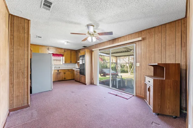 a view of a kitchen with refrigerator and a sink
