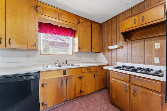 a kitchen with stainless steel appliances granite countertop a sink stove and cabinets