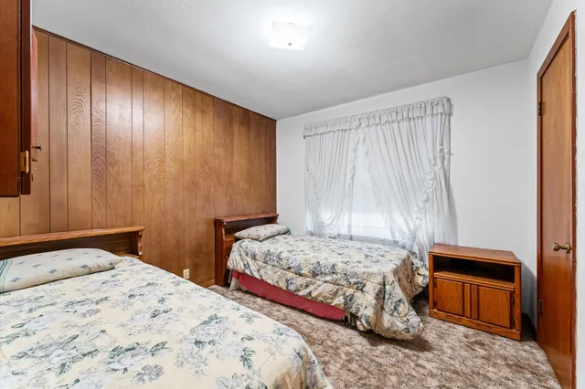 a bedroom with a bed and a dresser