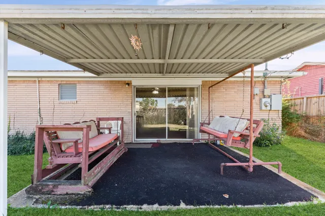 a backyard of a house with yard and outdoor seating