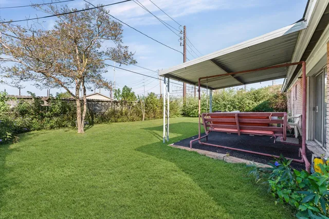 a view of a backyard with wooden fence