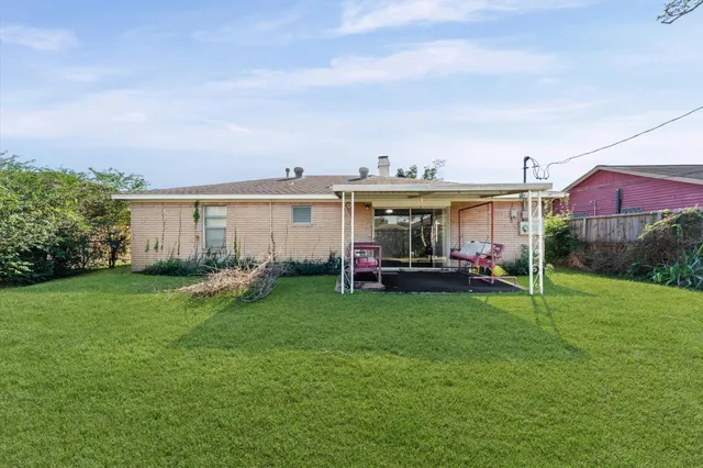 a view of a house with backyard sitting area and garden