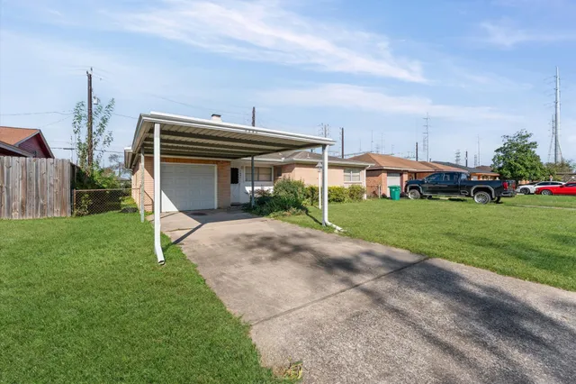a view of a house with a yard and sitting area