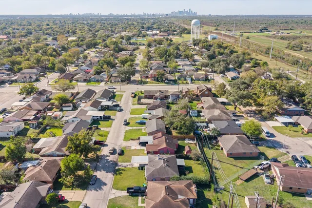 an aerial view of residential houses with outdoor space and swimming pool