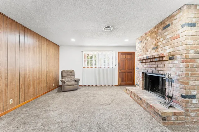a view of a livingroom with furniture and a fireplace