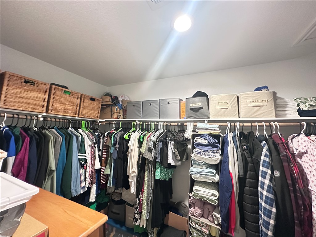 7649 Herd Rider Lane Corpus Christi, TX 78414 - Photo 10 of 18 a view of walk in closet with clothes and shoes