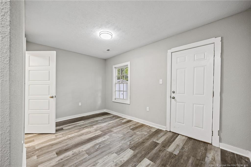 1601 Camden Road Fayetteville, NC 28306 - Photo 15 of 31 a view of room with window and hardwood floor