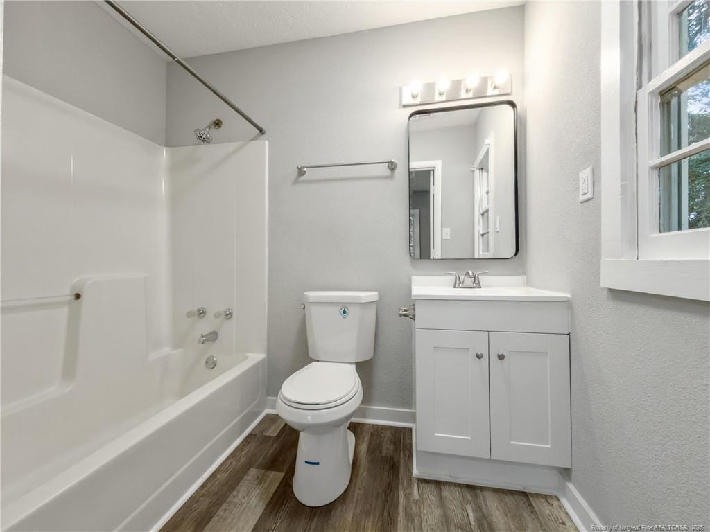 1601 Camden Road Fayetteville, NC 28306 - Photo 17 of 31 a bathroom with a toilet sink and mirror