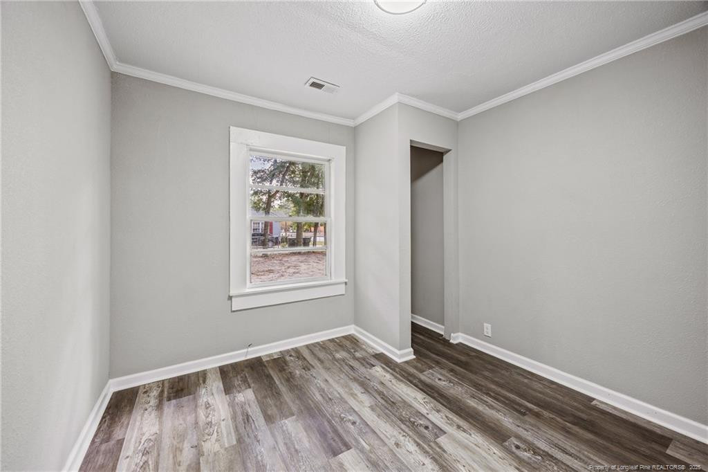 1601 Camden Road Fayetteville, NC 28306 - Photo 18 of 31 an empty room with wooden floor and windows