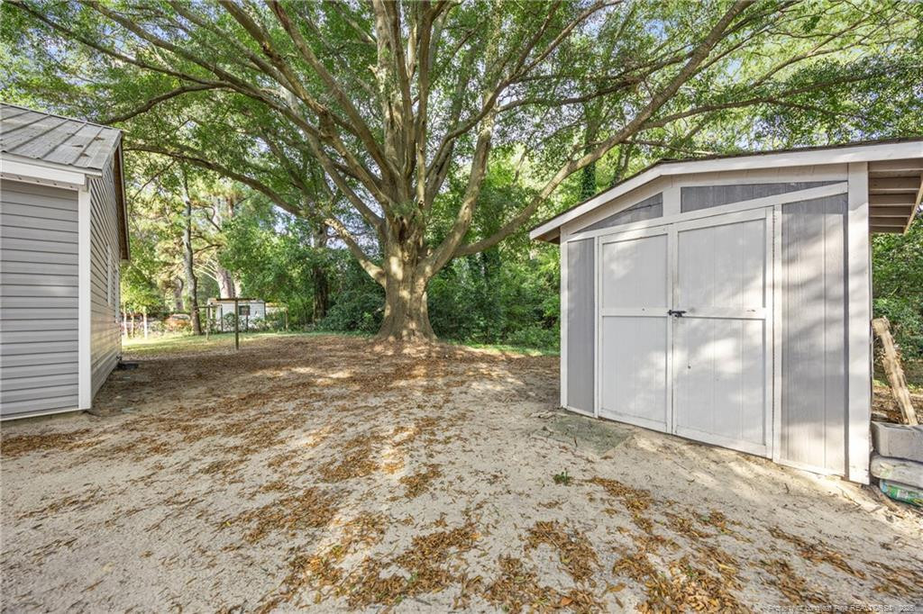1601 Camden Road Fayetteville, NC 28306 - Photo 23 of 31 a backyard of a house with basket ball court and glass windows
