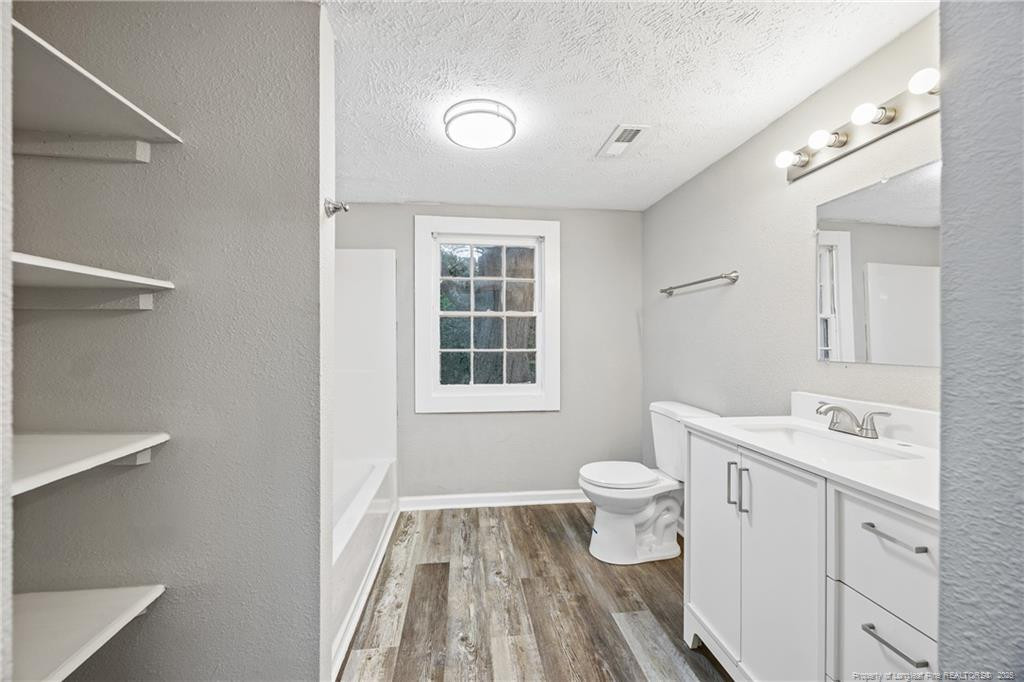 1601 Camden Road Fayetteville, NC 28306 - Photo 8 of 31 a bathroom with a sink a toilet and a mirror