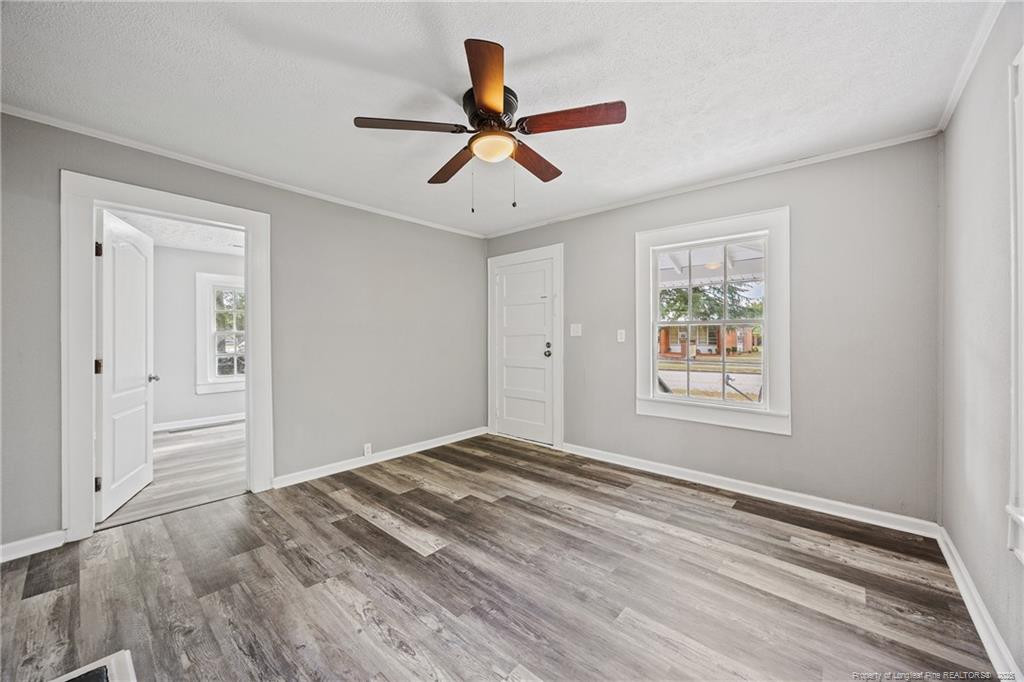 1601 Camden Road Fayetteville, NC 28306 - Photo 10 of 31 a view of empty room with wooden floor and ceiling fan