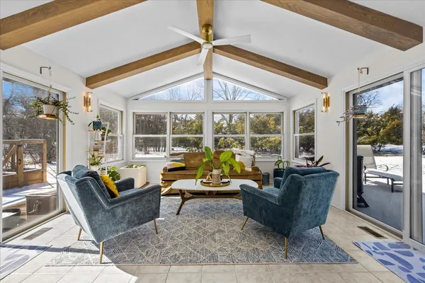 a living room with furniture and large windows