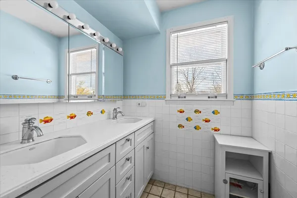 a bathroom with a sink a toilet and a window