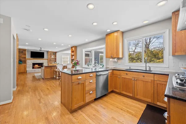 a large kitchen with stainless steel appliances kitchen island granite countertop a large cabinets and sink