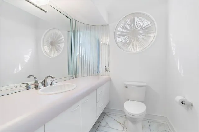 a large bathroom with a granite countertop sink and a mirror