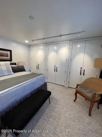 a bed room with a bed and a chair